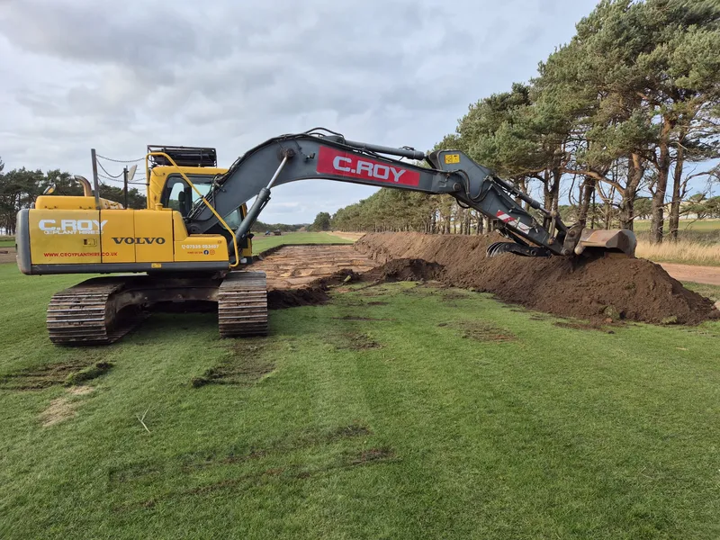 C.ROY 20-tonne excavator stripping topsoil on a grass field