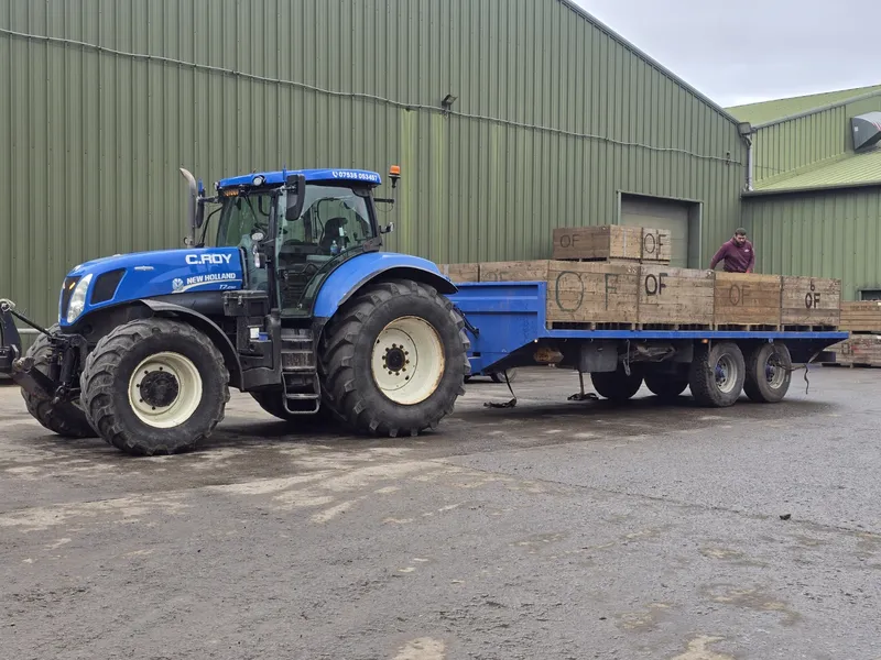 C.ROY tractor with flatbed trailer loaded for haulage